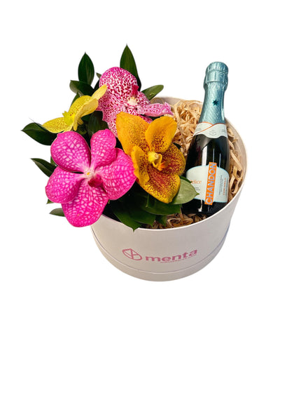 Delice-caja redonda blanca con orquídeas vanda y bebida