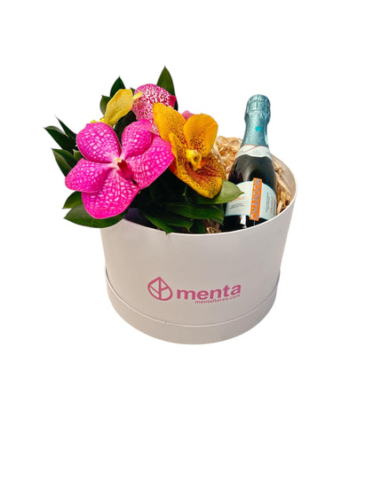 Delice-caja redonda blanca con orquídeas vanda y bebida