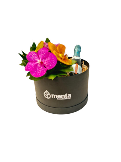Delice-caja redonda negra con orquídeas vanda y bebida